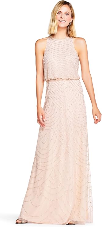 Woman wearing blush pink beaded halter evening gown, full-length, perfect for weddings and formal occasions.